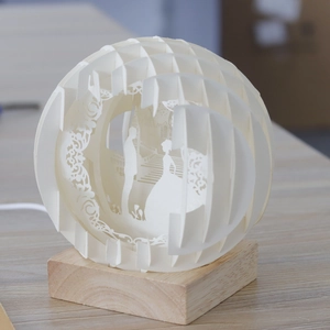 3D paper-cut sphere night light with romantic wedding silhouette and wooden base