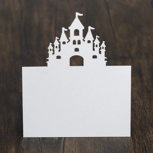 Detail of white laser-cut castle silhouette card with a blank space for writing names