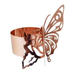 Detailed macro view of laser-cut butterfly napkin ring in rose gold metallic finish