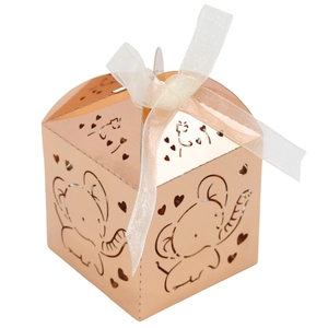 Close-up of rose gold hollow elephant candy box with laser cut hearts and white ribbon bow