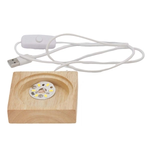 Detail of solid wood LED light base with USB cable and switch for paper sculpture lamps
