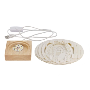 Detail of DIY 3D paper carving lamp components with wooden LED base and USB cable