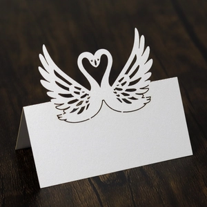 Detailed laser-cut swan place card for wedding table with white pearlescent paper