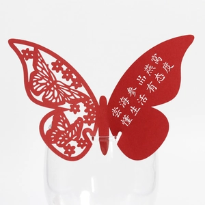 Red butterfly laser cut wine glass place card with white artistic greeting text