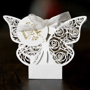Detail of white laser-cut butterfly gift box with rose patterns and Thank You tag