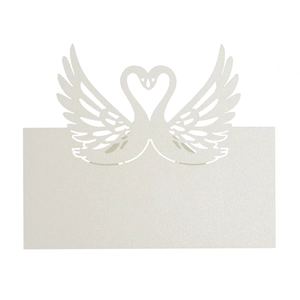 Detailed laser-cut swan heart design on white pearlescent paper wedding place card
