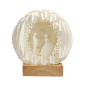 Spherical laser-cut paper night light with wedding silhouettes and wood base