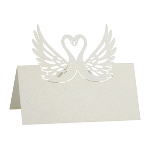 Detail of laser-cut swan heart place card in pearlescent white for wedding tables