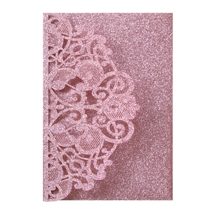 Detailed macro view of pink rose gold laser-cut glitter wedding invitation card cover