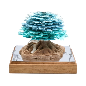 Macro shot of 3D paper tree art with blue foliage and reflective deer figurine