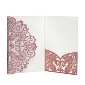 Detail of laser cut rose gold glitter wedding invitation sleeve with floral vine pattern