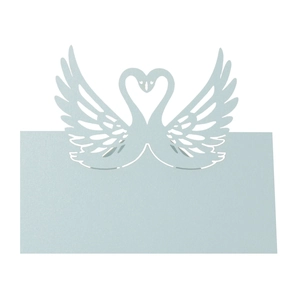Close-up of laser-cut swan heart place card in light blue pearlescent paper for weddings