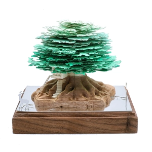 3D treehouse paper sculpture with laser-cut layers and deer decor on a wooden base