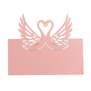 Detailed close-up of pink laser-cut swan place card with elegant heart-shaped design