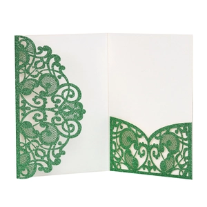 Detail of dark green laser cut wedding invitation with glitter finish and pocket