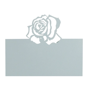 Detail of light blue laser-cut paper place card featuring delicate rose floral design