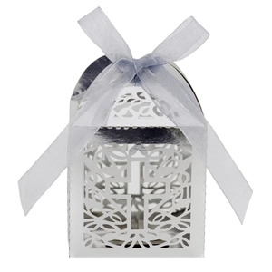 Detail of laser-cut cross on pearlescent white favor box with a blue organza ribbon