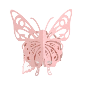 Close-up of pink laser-cut butterfly napkin ring with intricate hollow floral patterns