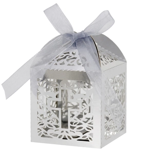 Detail of laser-cut cross hollow candy box with light blue silk bow for wedding