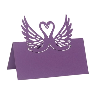 Detail of laser-cut purple swan heart place card with intricate镂空patterns for weddings