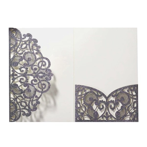 Close-up of laser-cut glitter purple wedding invitation with intricate lace hollow patterns