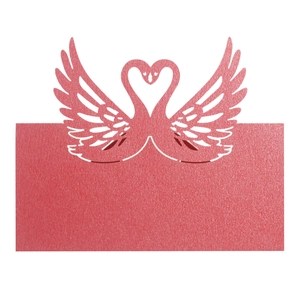 Macro view of red laser-cut swan heart place card with shimmering pearlescent finish