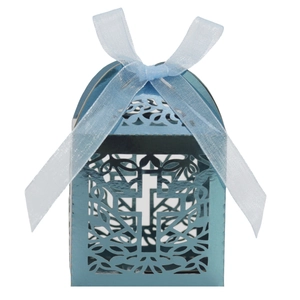 Detail view of electric blue laser-cut candy box with cross pattern and chiffon ribbon