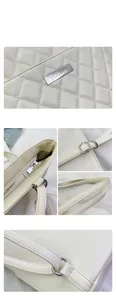 Detailed macro view of cream quilted faux leather texture and silver zipper hardware
