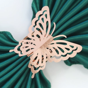 Close-up of rose gold butterfly napkin ring with intricate laser-cut hollow details