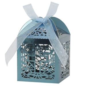 Detail of light blue laser-cut cross candy box with sheer ribbon for baptism events