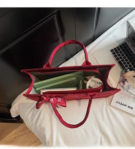 Internal view showing large capacity and red jacquard pleated texture of the tote bag