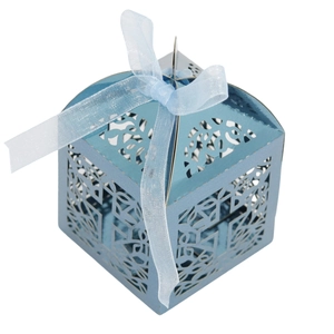 Detail view of light blue hollow-out gift box with laser-cut patterns and ribbon bow