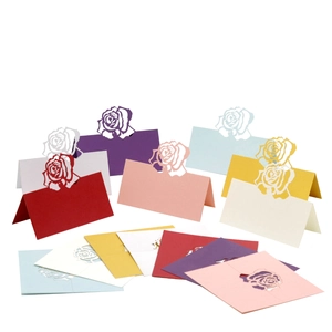 Laser cut rose place cards in assorted pearlescent colors for wedding table settings