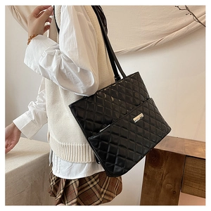 Fashionable black quilted tote bag with large capacity and silver metal logo on front