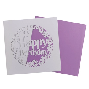 Detailed laser-cut birthday card with white daisy patterns and a purple envelope