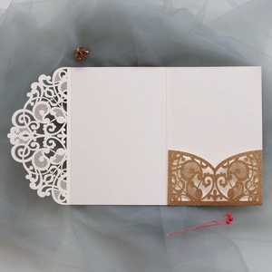 Detail view of champagne gold glitter laser-cut floral pocket and wedding invitation cover
