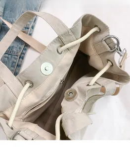 Internal detail of nylon bucket bag featuring magnetic closure and inner zipper pocket
