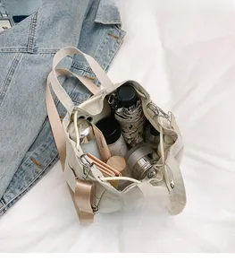 Top view of cream nylon bucket bag showing large capacity for umbrella and daily essentials