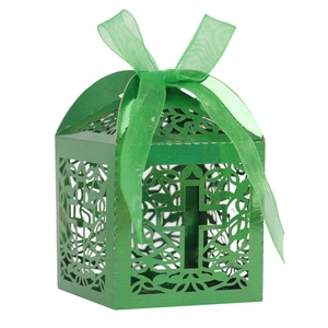 Macro detail of laser-cut cross design on green pearlescent paper wedding favor box