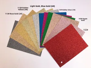 Macro view of multi-color glitter paper sheets with shimmering metallic textures