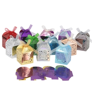 Flat paper mold and assembled pink elephant candy boxes with ribbons for parties