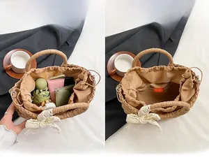 Internal view of a semi-circular straw beach bag with lace bow and drawstring closure