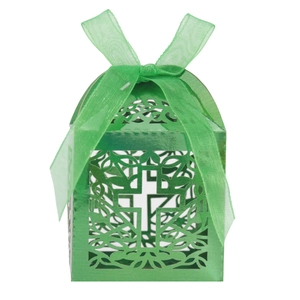 Close-up of laser-cut green favor box with cross design and matching organza ribbon