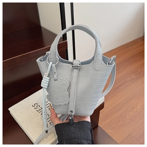 Light blue crocodile pattern bucket bag with metal lock and cute puppy charm detail