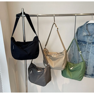 Detail of nylon crossbody bags in four colors with adjustable straps and zipper closure
