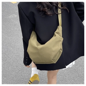 Detailed view of the khaki corduroy crescent bag showing the ribbed texture and wide strap
