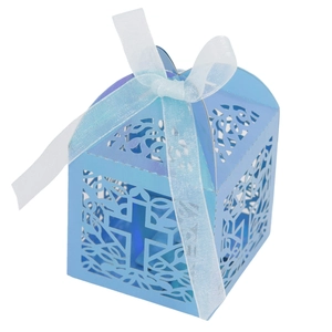 Detail of blue laser-cut candy box with cross pattern and white ribbon bow