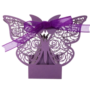 Close-up of purple laser-cut wedding candy box with butterfly and rose pattern
