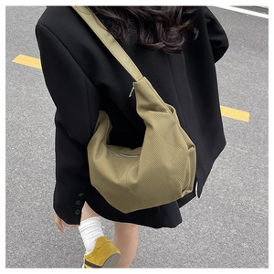 Detail of the large olive hobo bag showing its textured material and soft slouchy design