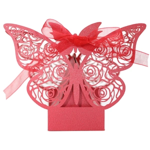 Detail of red laser-cut butterfly candy box with rose patterns and a silk ribbon bow